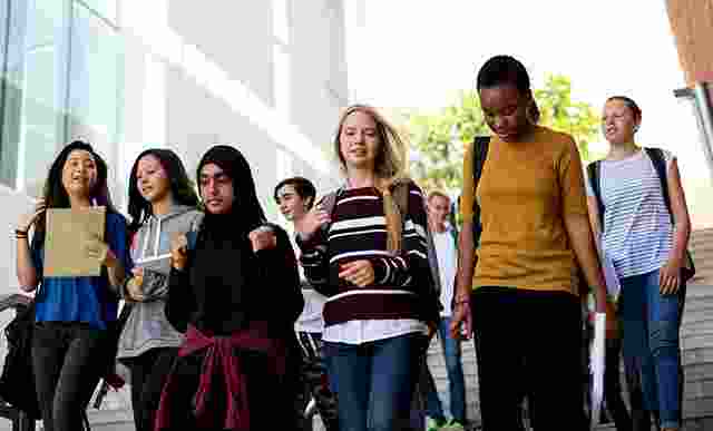 Photograph of a group of students walking down steps at a University campus