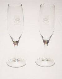 Photograph of two New College Champagne Flutes with the college coat of arms